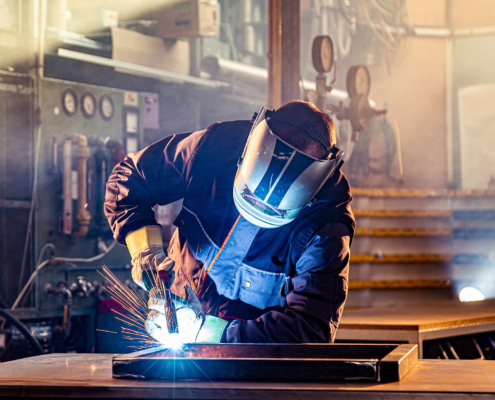 A welder welding in factory