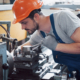 professional engineer metalworker operating CNC milling machine