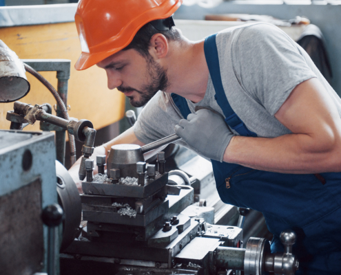 Experienced operator in a hard hat. Metalworking industry