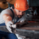 Metalworking industry concept professional engineer metalworker operating CNC milling machine
